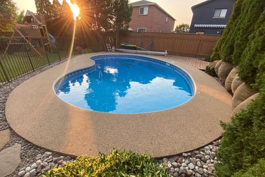 A round pool with a honey-gold Gator Grip deck, photographed at golden hour